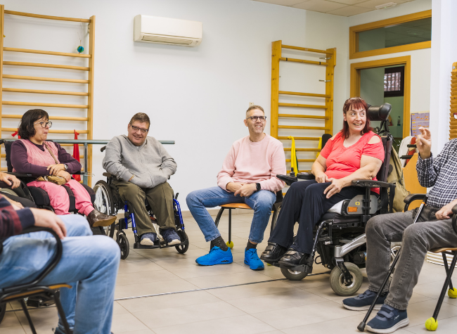 A group of adults sitting in a circle talking
