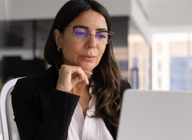 Professional woman looking at laptop screen